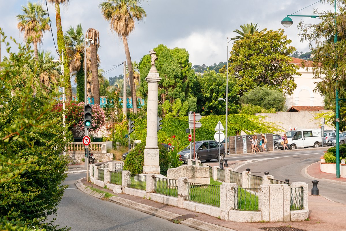 The Napoleon column with its marble bust among palm trees on Square Nabonnand in Golfe-Juan