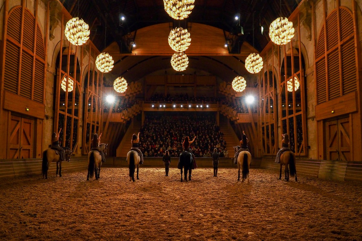 Riders of the Académie équestre salute the audience in the riding hall of the Grande Écurie at Versailles