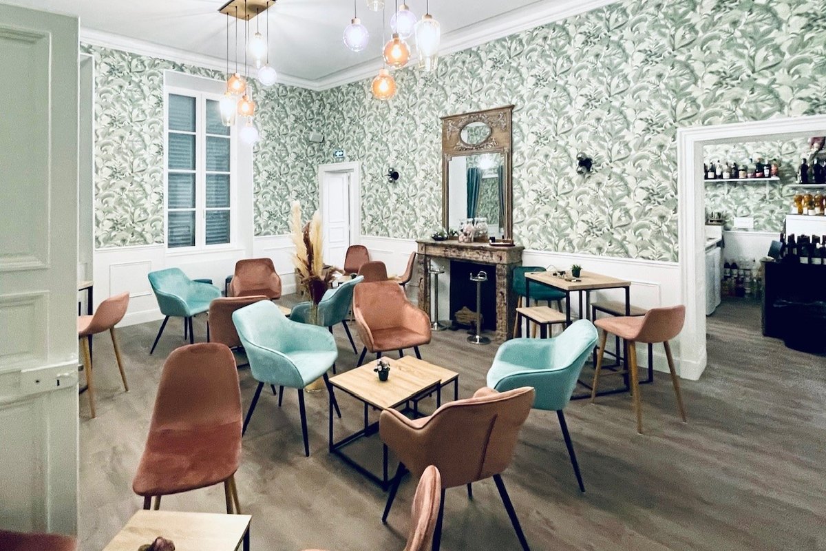 Velvet chairs and botanical wallpaper in the wine and cocktail bar Chez Les Filles, rue Colbert, Versailles