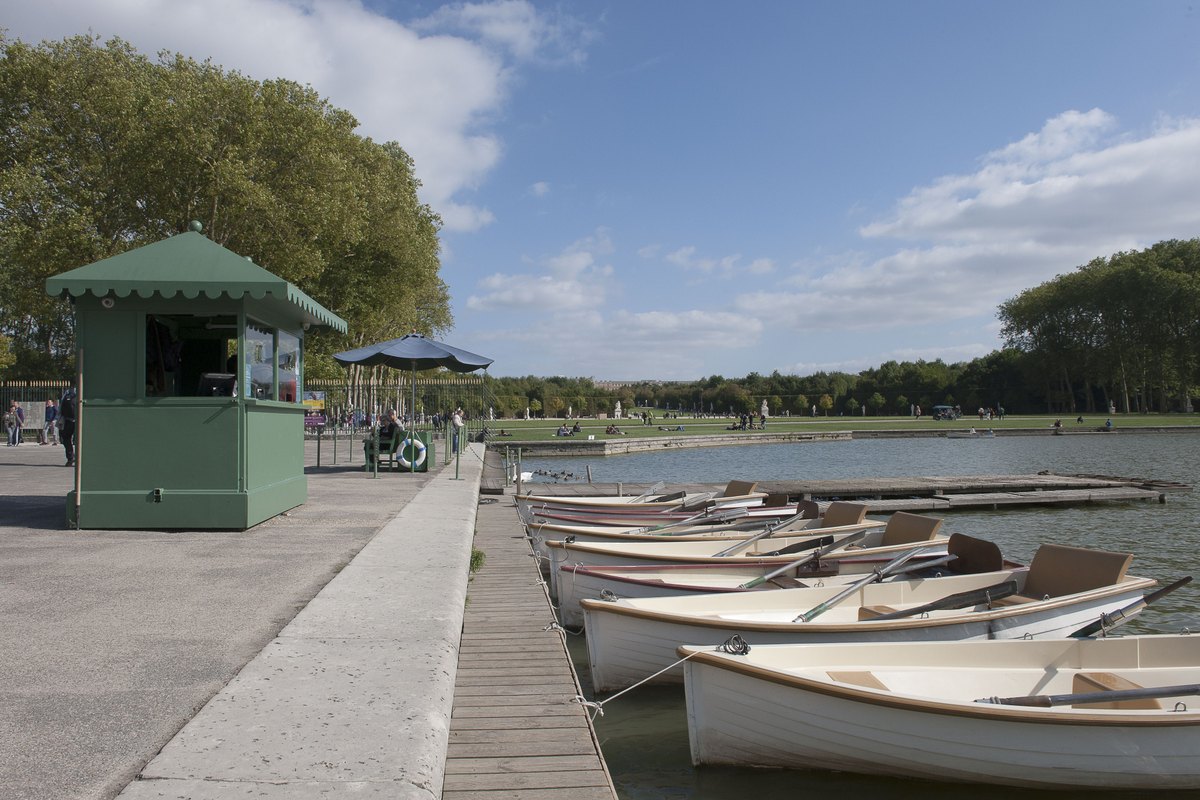 White rowing boats moored at the hire point on the Grand Canal in the Park of Versailles