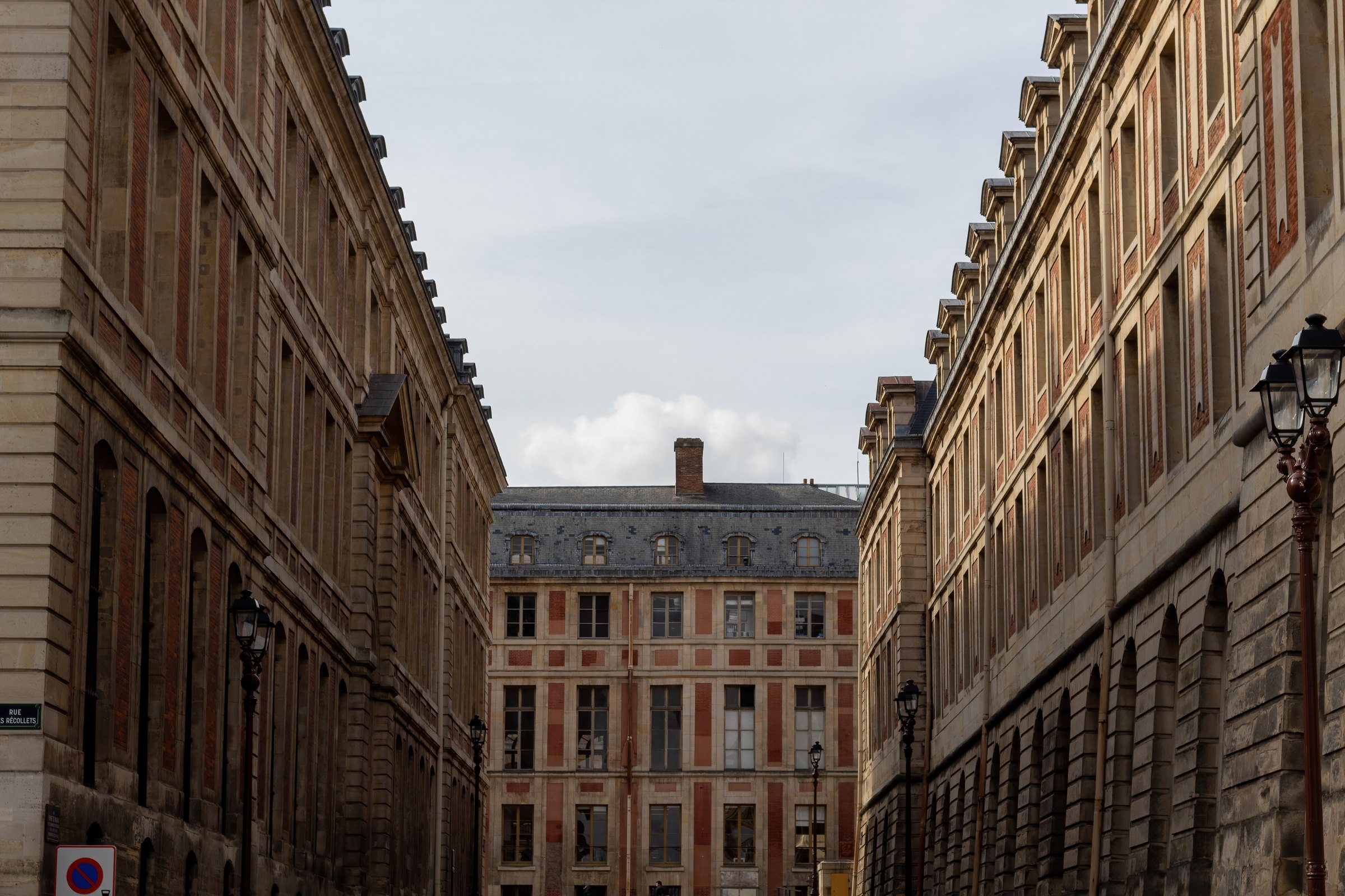 Tall stone buildings along a street in Versailles