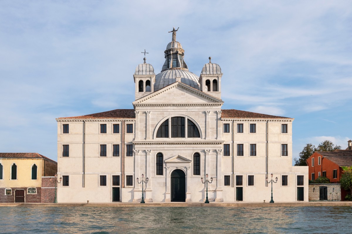 Front view of the white Palladian-style façade of Airelles Palladio hotel across the water, Venice