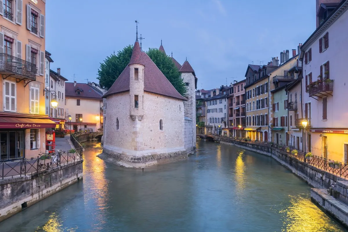 The Palais de l'Isle in the Thiou canal in Annecy's old town at dusk