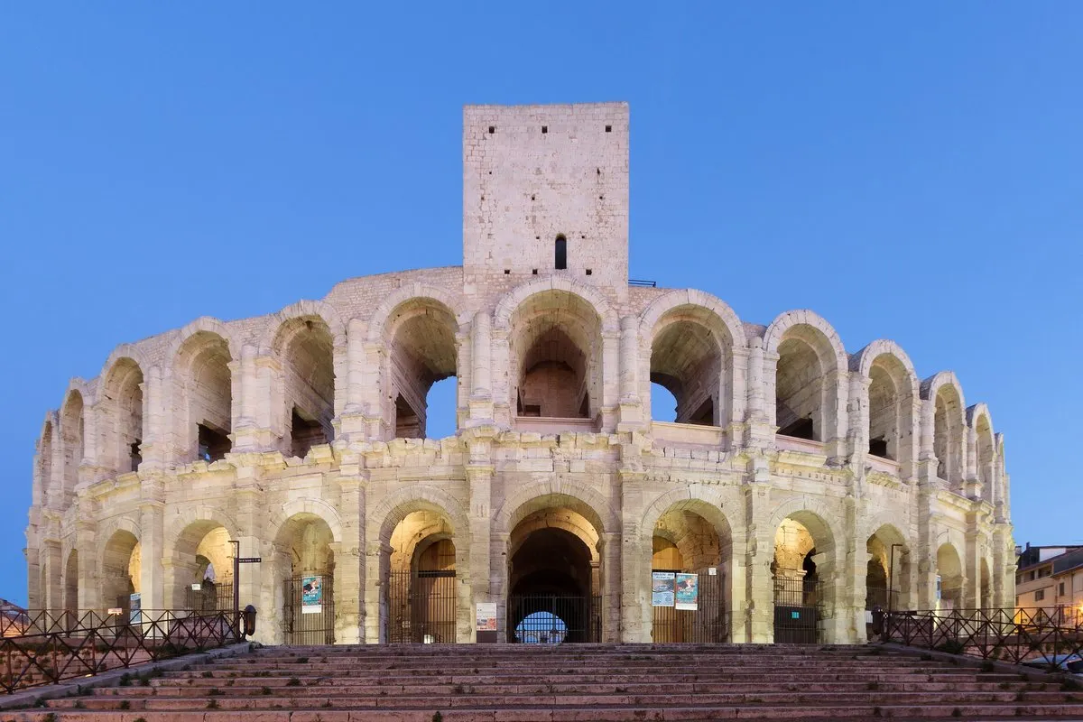The Roman amphitheatre in Arles lit up at dusk