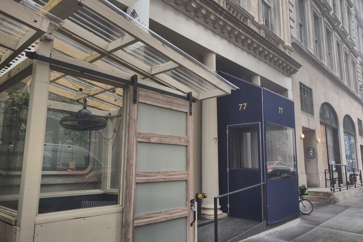 Atera restaurant entrance at 77, dark blue vestibule and awning on a NYC street corner