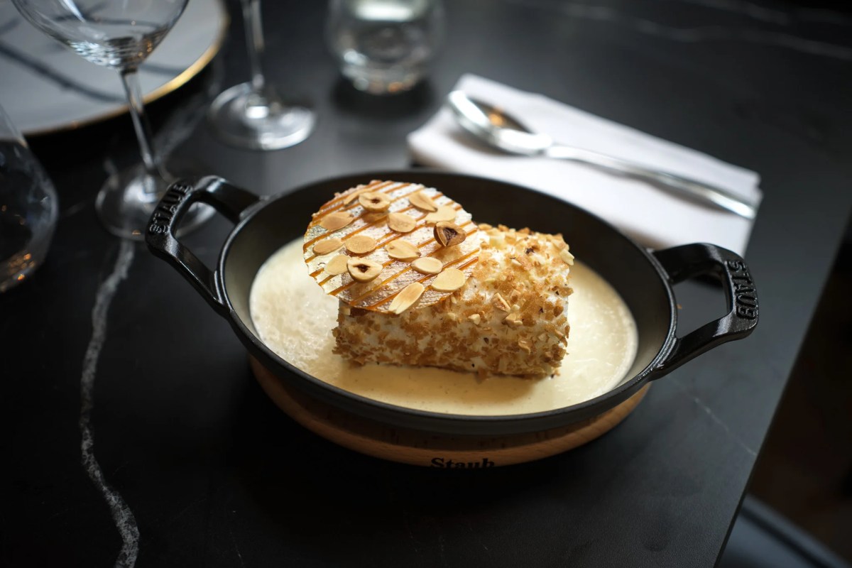 Dessert in a small Staub dish with almond crust and creamy sauce