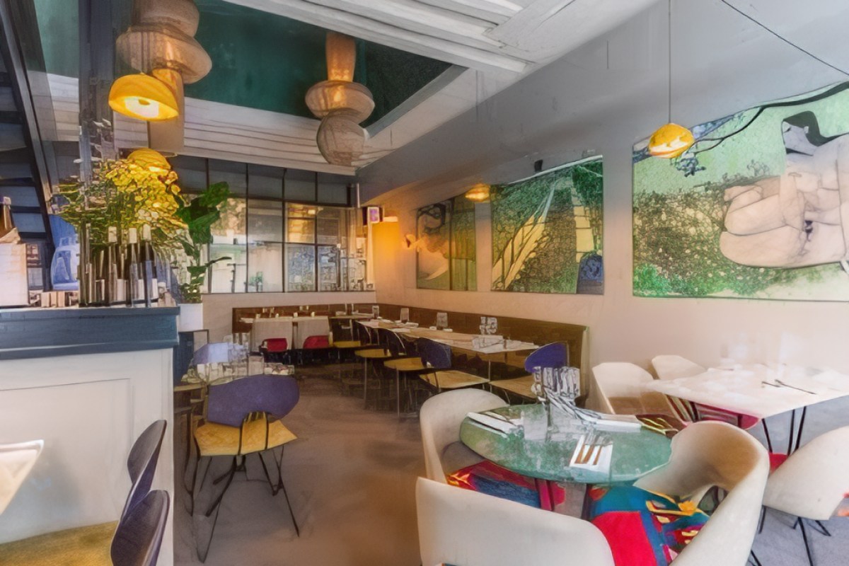 Wide view of the restaurant's dining room with colorful chairs, pendant lights, and wall art