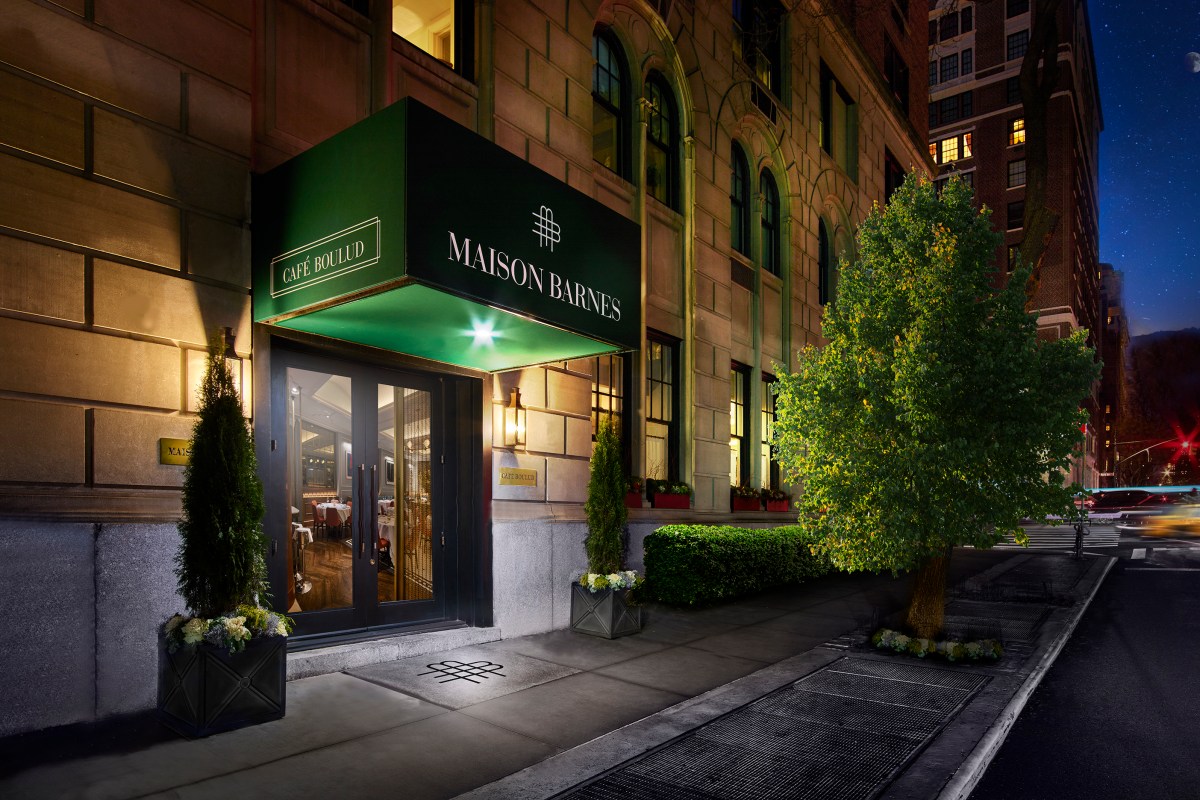 Exterior entrance of Café Boulud at Maison Barnes at night, green awning with signage