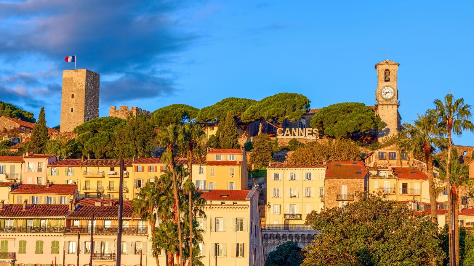 Le Suquet, the old town of Cannes, with its castle tower, the church bell tower and pines above pastel façades