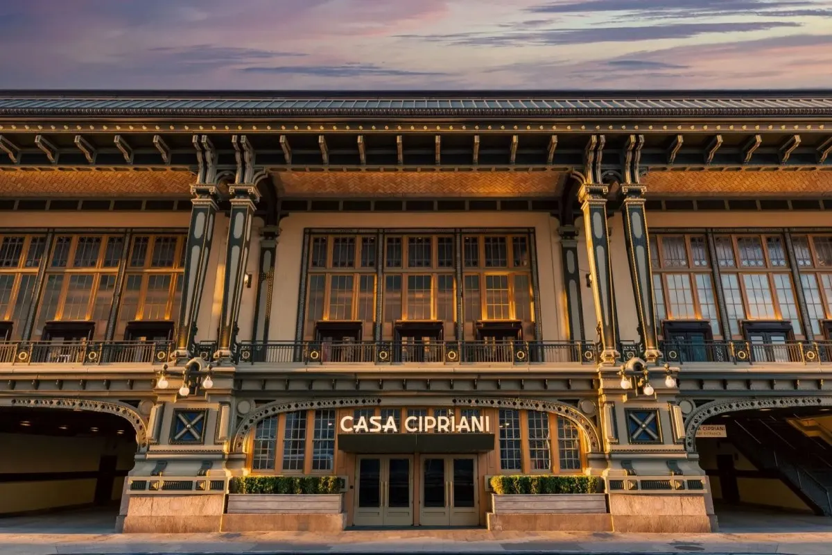 Facade of Casa Cipriani New York building at sunset with illuminated sign and ornate architectural details