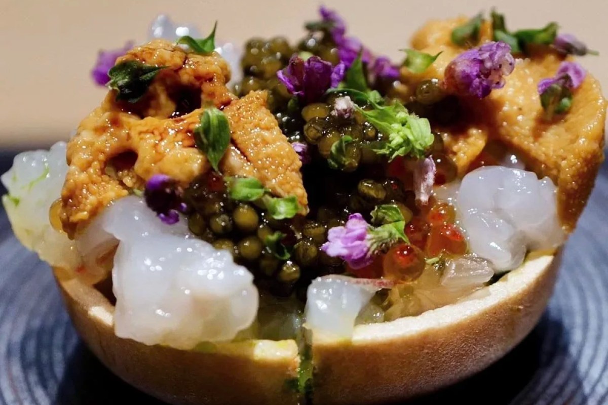 Elaborate seafood dish with uni, caviar, shrimp and edible flowers