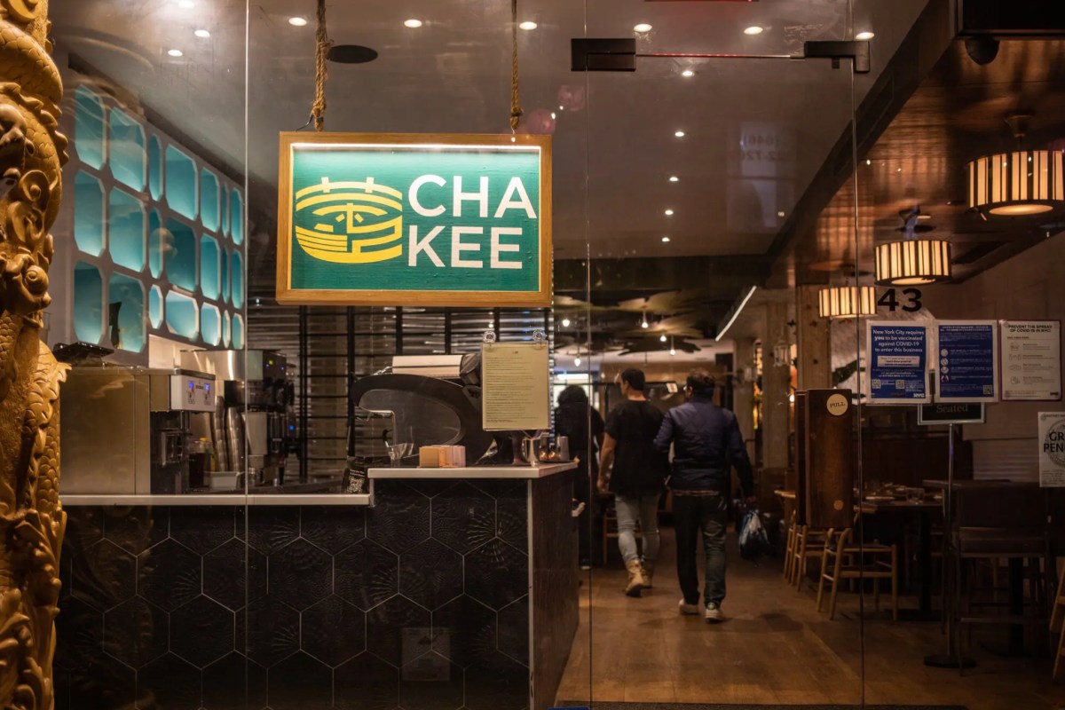 Cha Kee restaurant storefront entrance at night with illuminated sign and interior visible