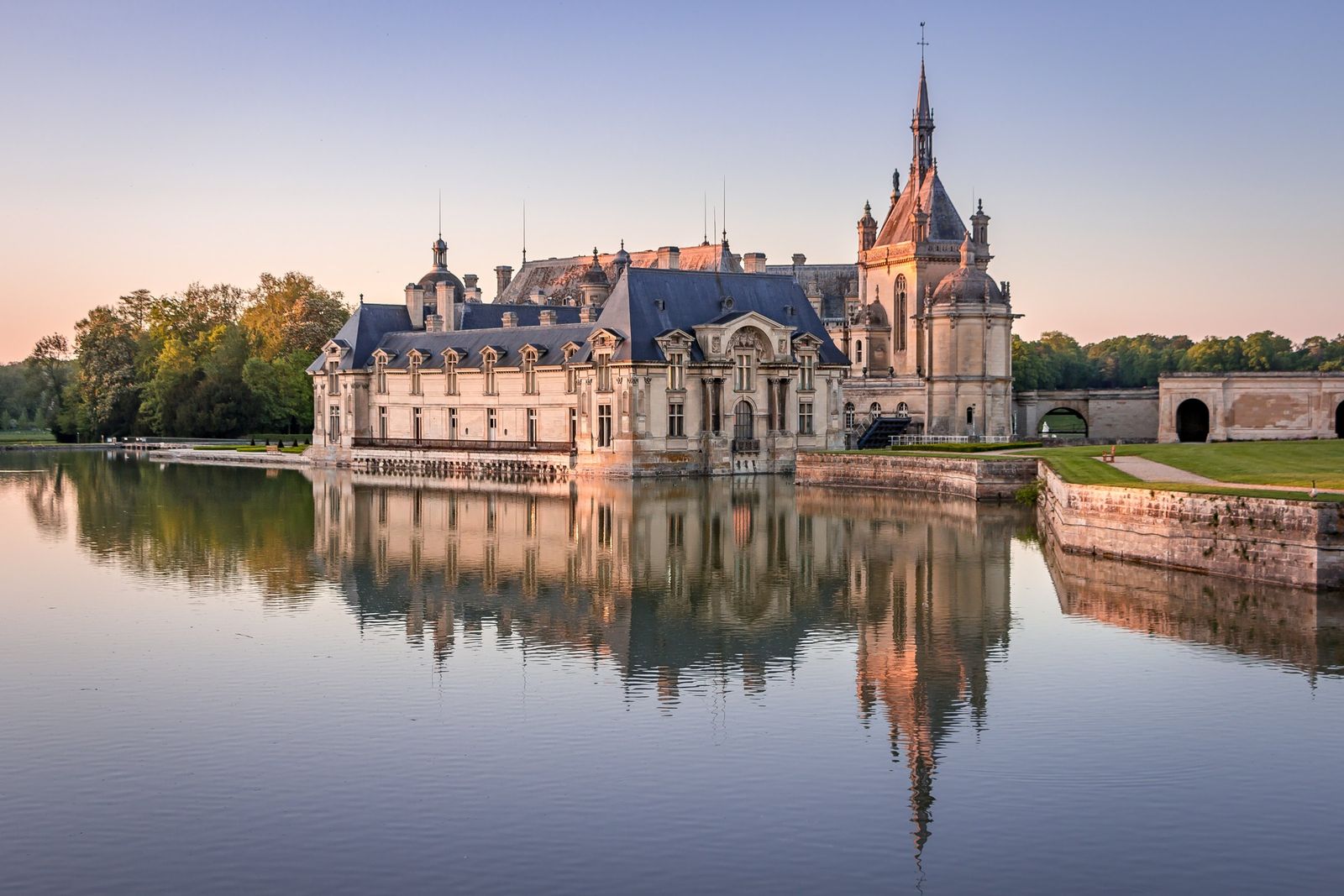 The Château de Chantilly reflected in its lake