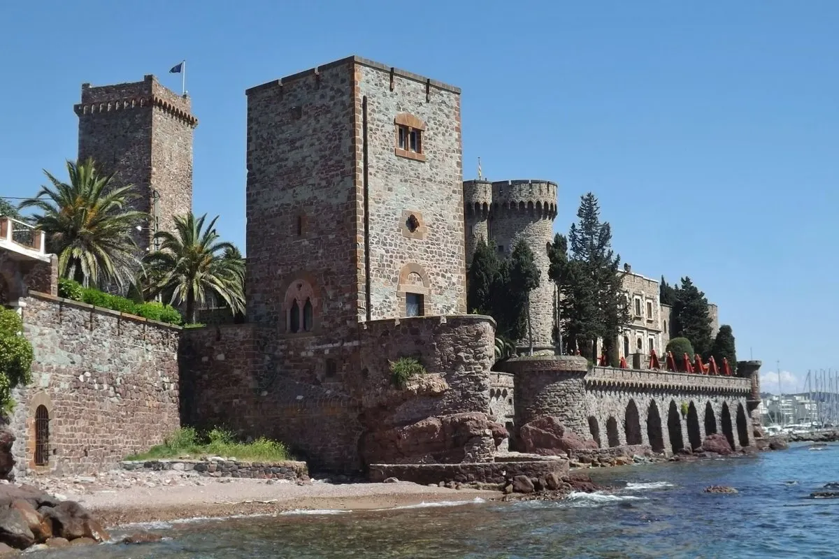 Château de la Napoule with its medieval stone towers and arcades by the water in Mandelieu-la-Napoule