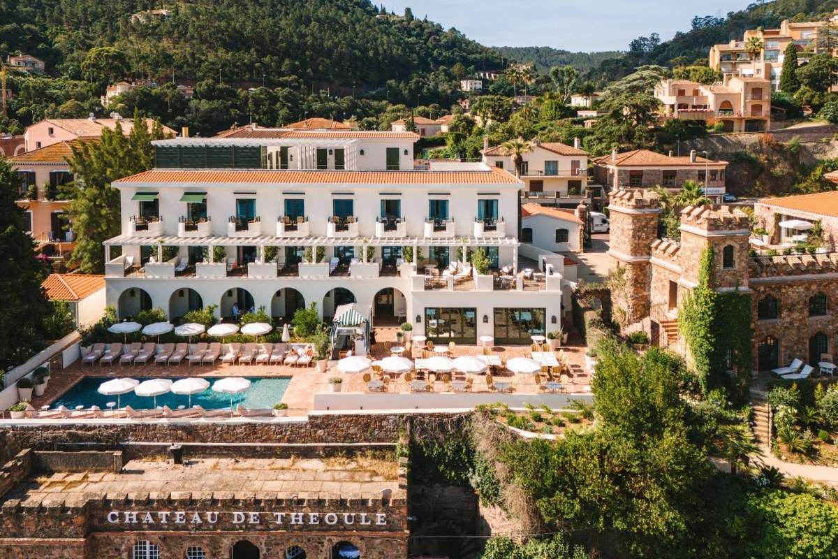 Aerial view of Château de Théoule hotel building with pool, terrace, and coastal hillside setting