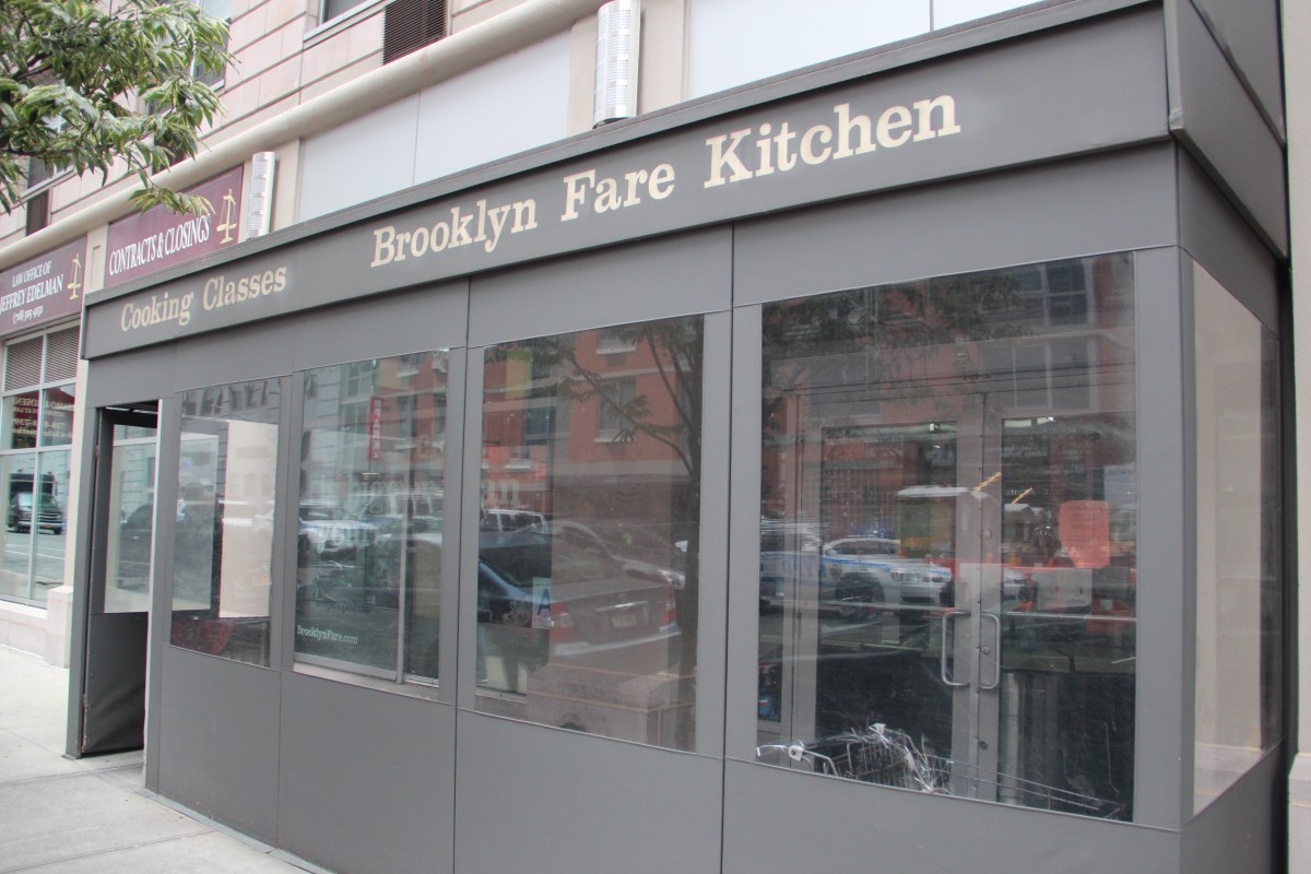 Exterior storefront signage reading 'Brooklyn Fare Kitchen' and 'Cooking Classes' with glass windows on a city street.