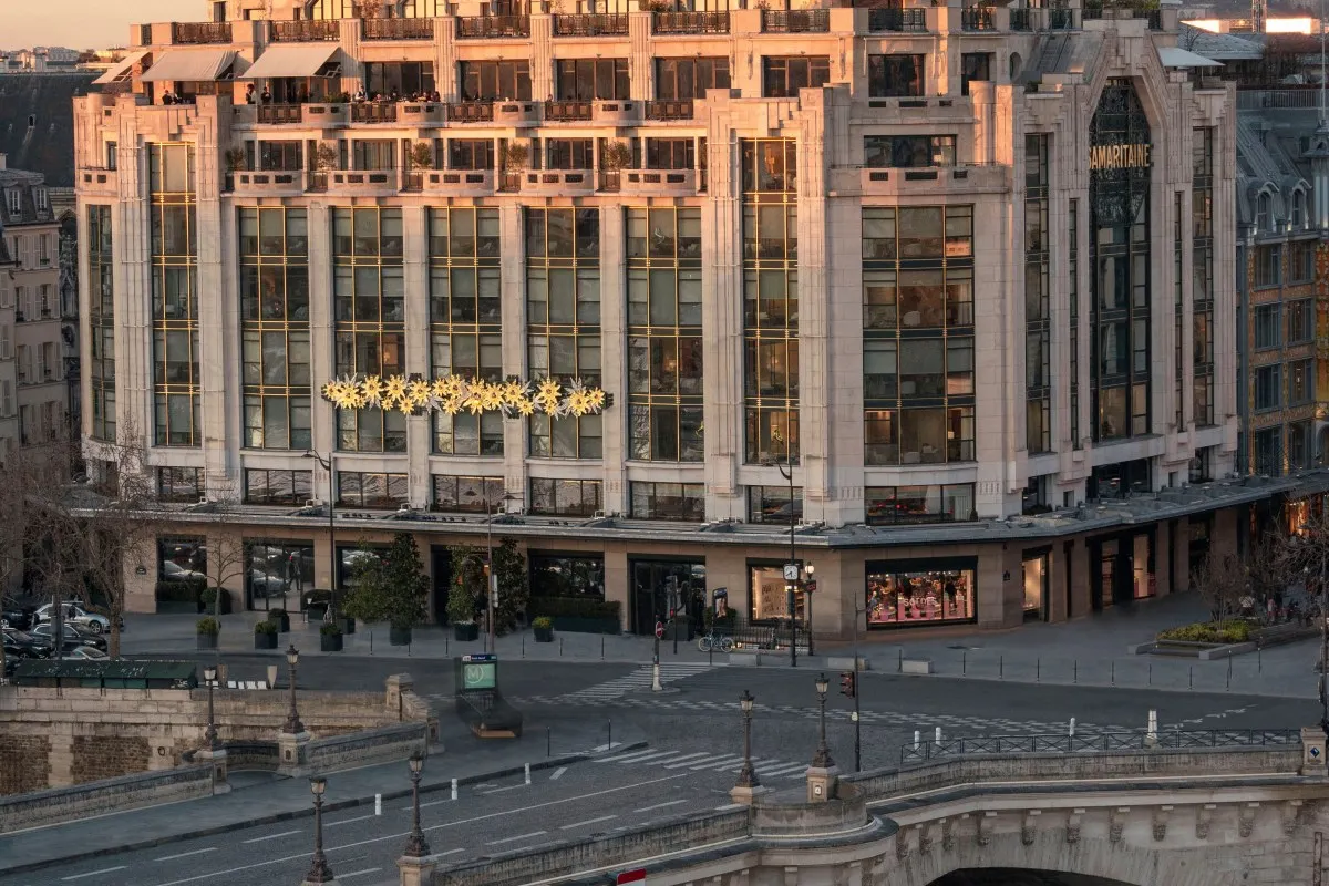 Aerial view of the Samaritaine building housing Cheval Blanc Paris at dusk, with Pont Neuf and Seine in foreground