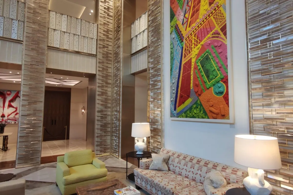 Elegant hotel lobby with modern art, patterned sofas, and marble floors