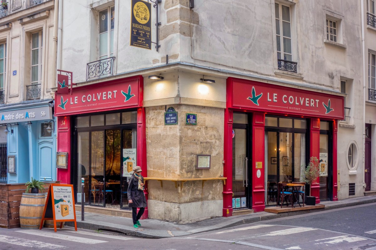 Exterior corner view of Le Colvert bistrot at 54 Rue Saint-André des Arts, Paris, with red storefront signage