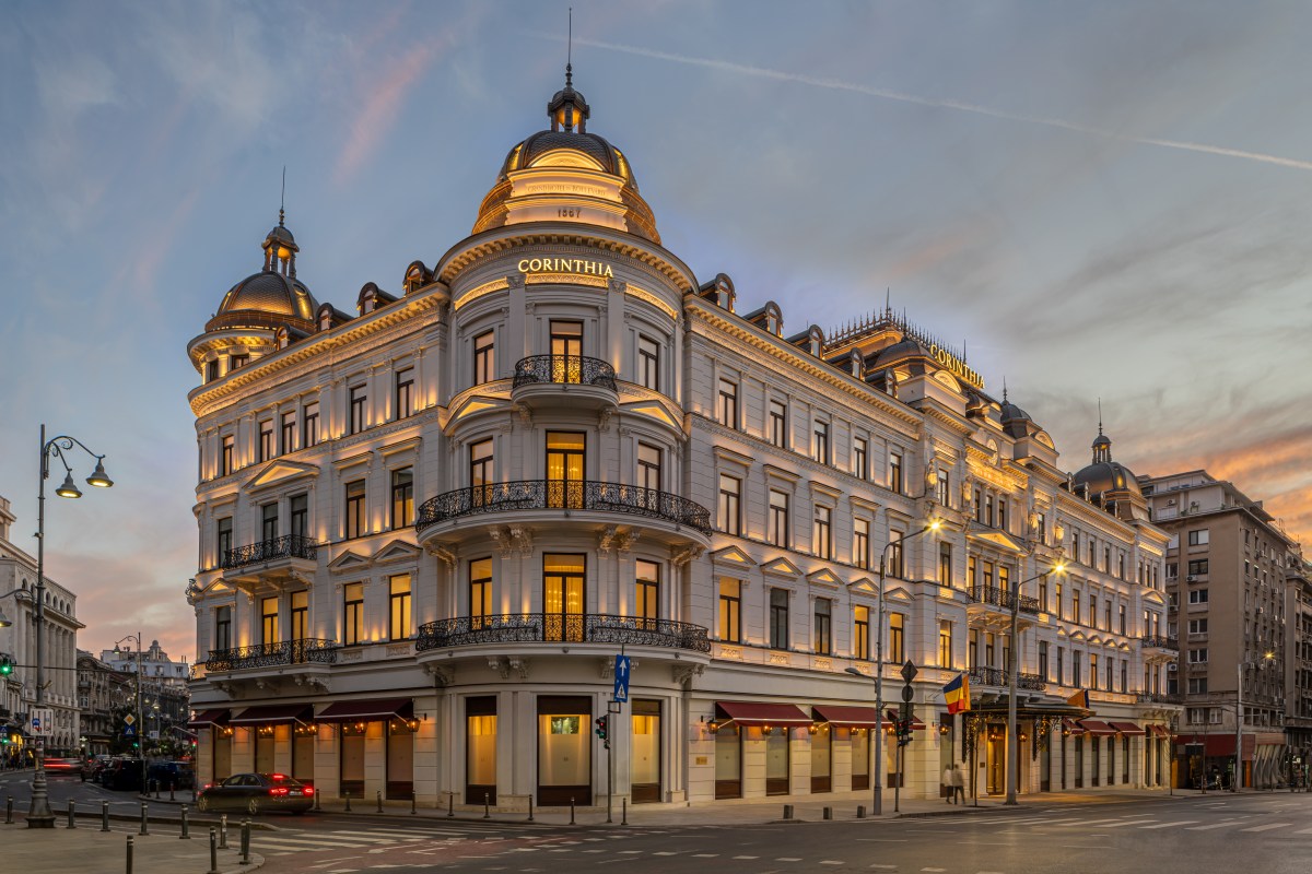 Exterior facade of Corinthia Grand Hotel du Boulevard Bucharest at dusk, corner view with illuminated domes and balconies