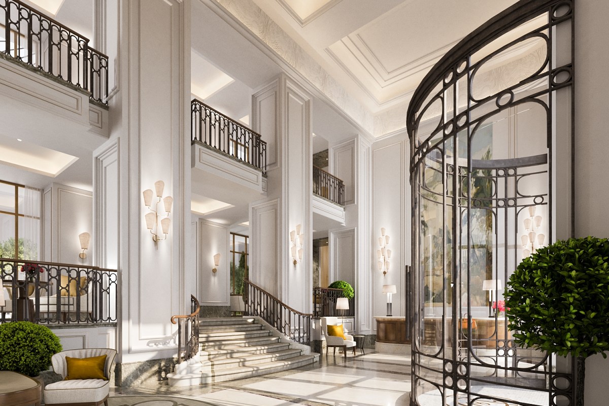 Grand hotel lobby with marble staircase, wrought-iron balustrades and a curved glass elevator