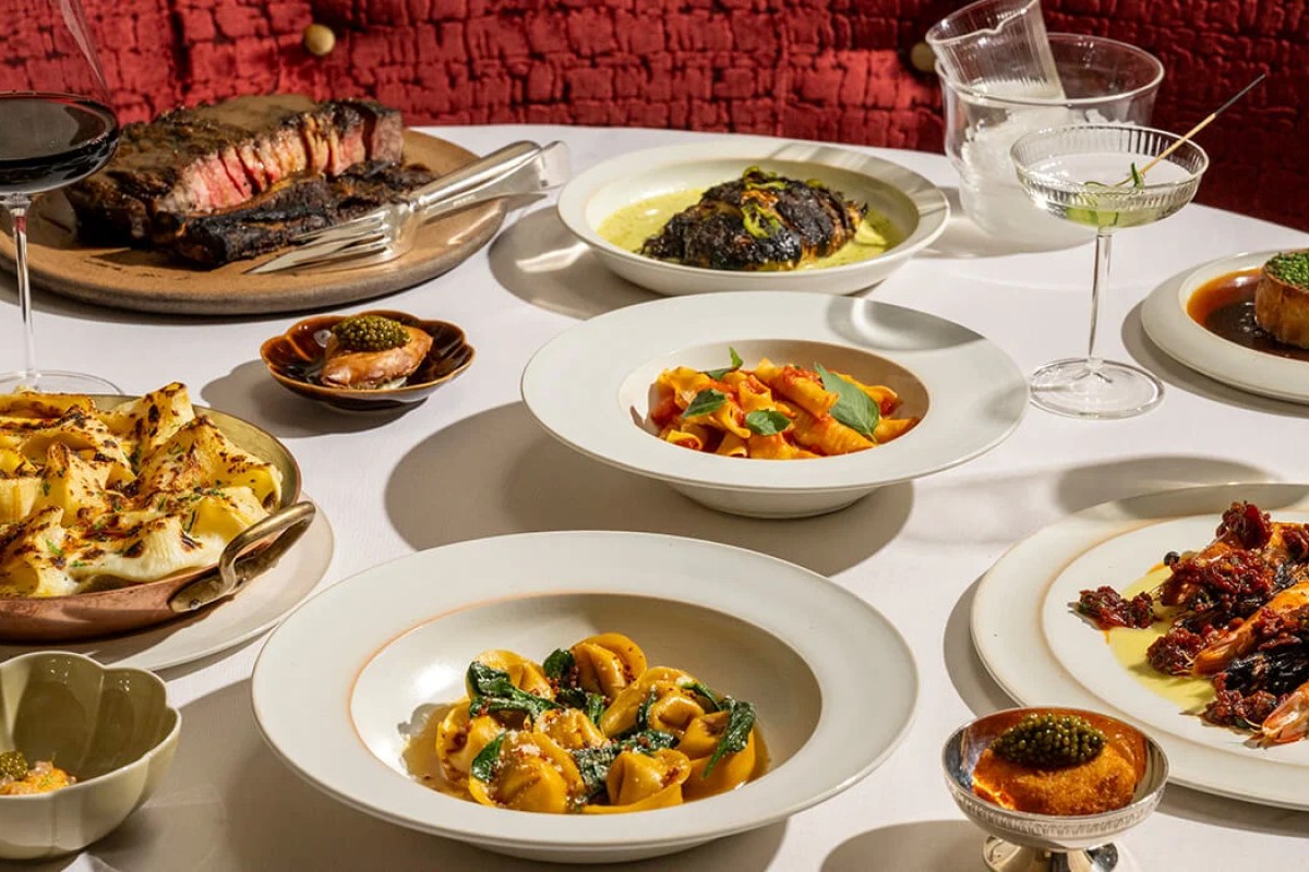 Table spread of pasta, steak, caviar and cocktails at Crane Club