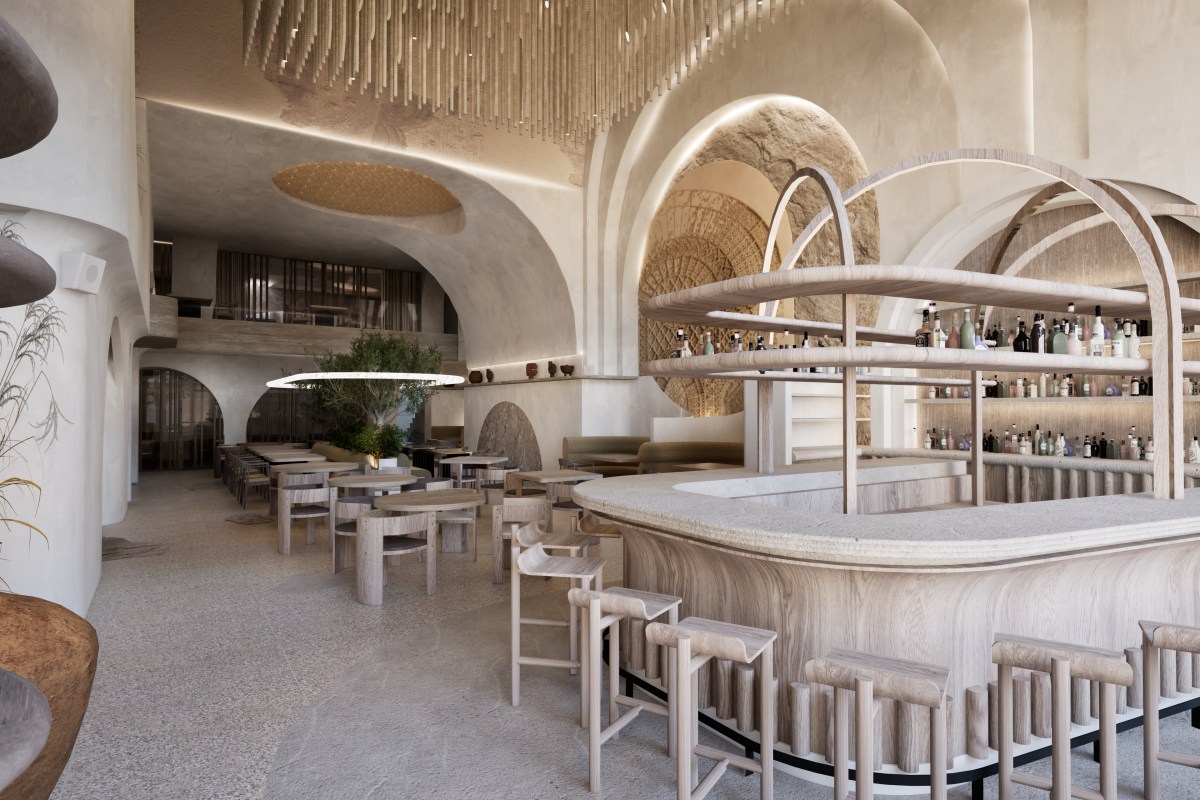 Mediterranean-style bar and dining area with arched stone walls, wood bar counter, and bottle-lined shelves