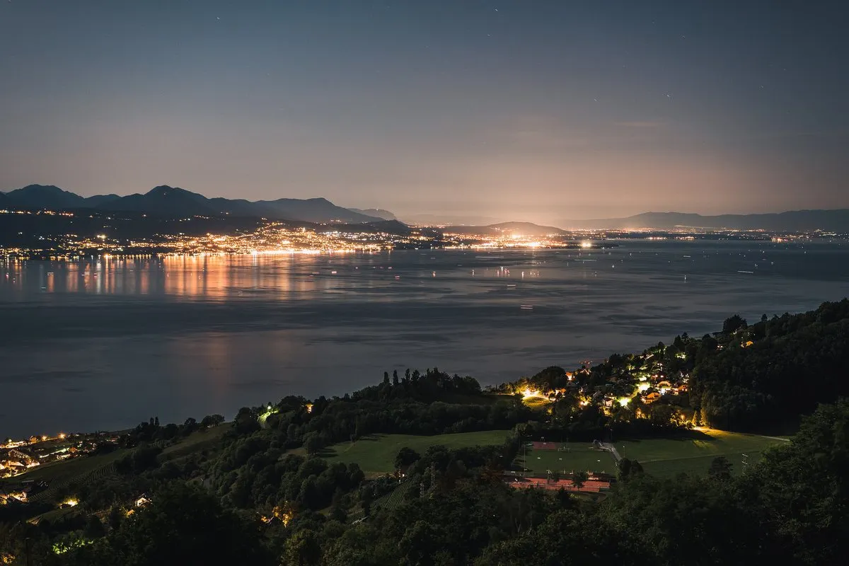 Évian-les-Bains lit up on Lake Geneva, seen from Lavaux at night