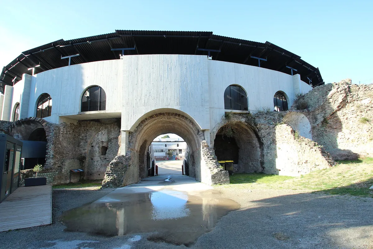 The Roman amphitheatre of Fréjus with its stone arches and modern white seating structure