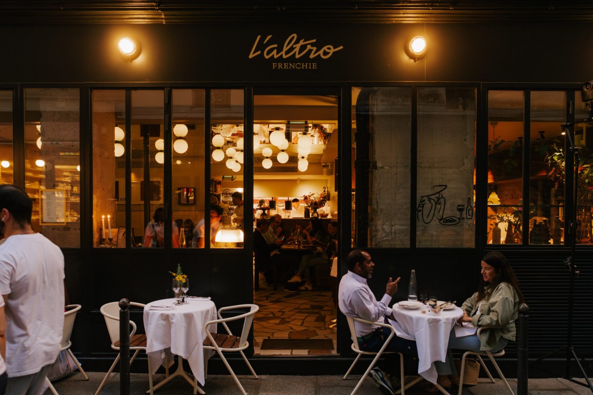 Frenchie restaurant exterior at night, L'Altro Frenchie signage, lit storefront with outdoor tables and diners