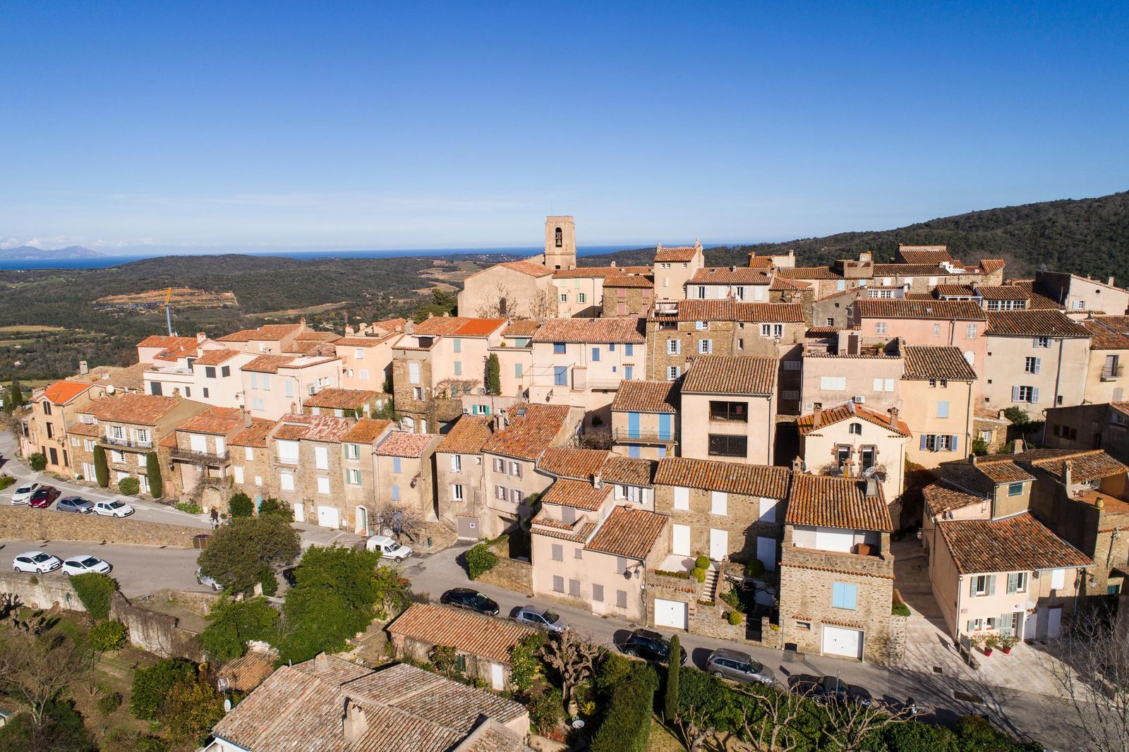 Gassin from the air: the hilltop village and its church above the vineyards and woods of the Saint-Tropez peninsula