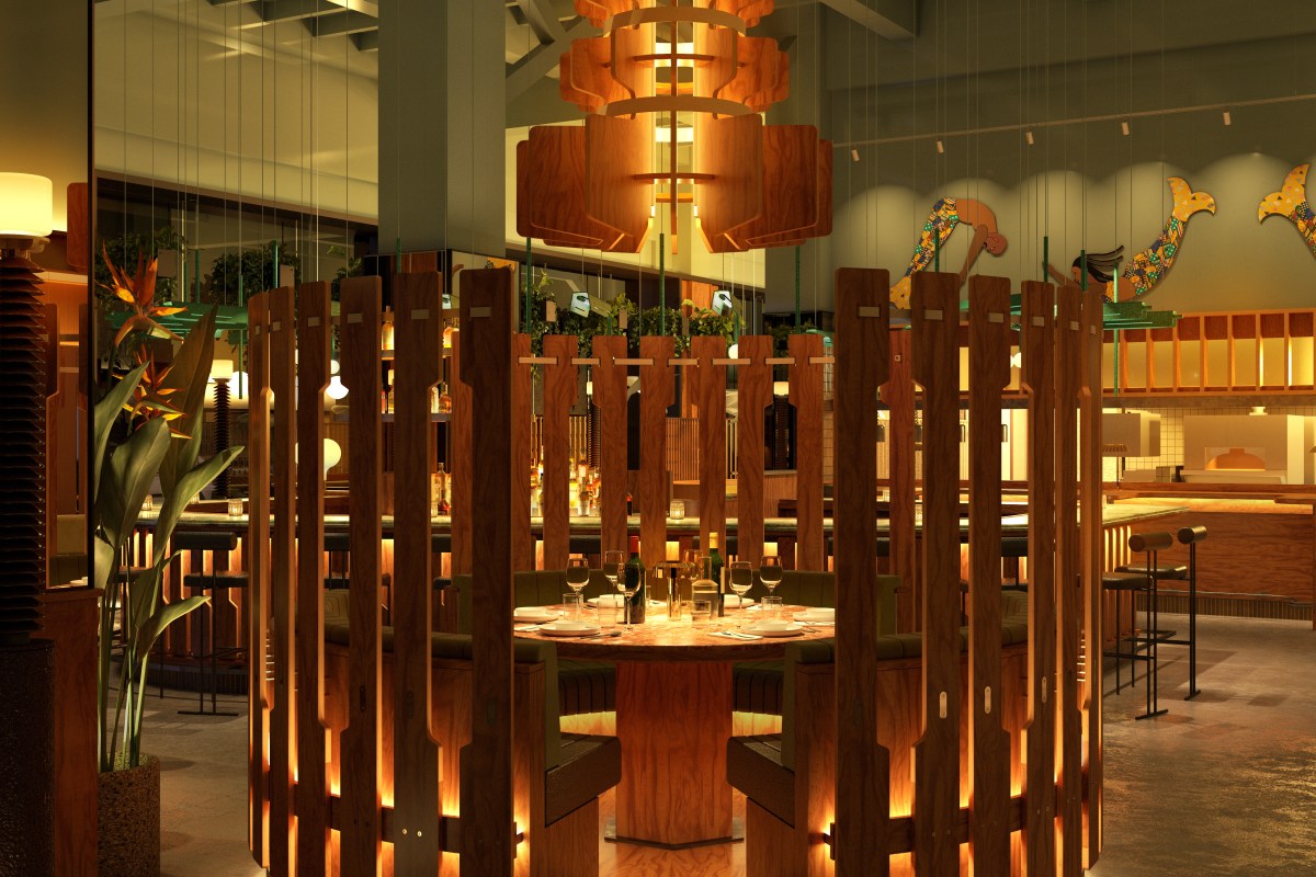 Interior dining room with wood slat dividers, round table set for dinner, and mermaid mural in background
