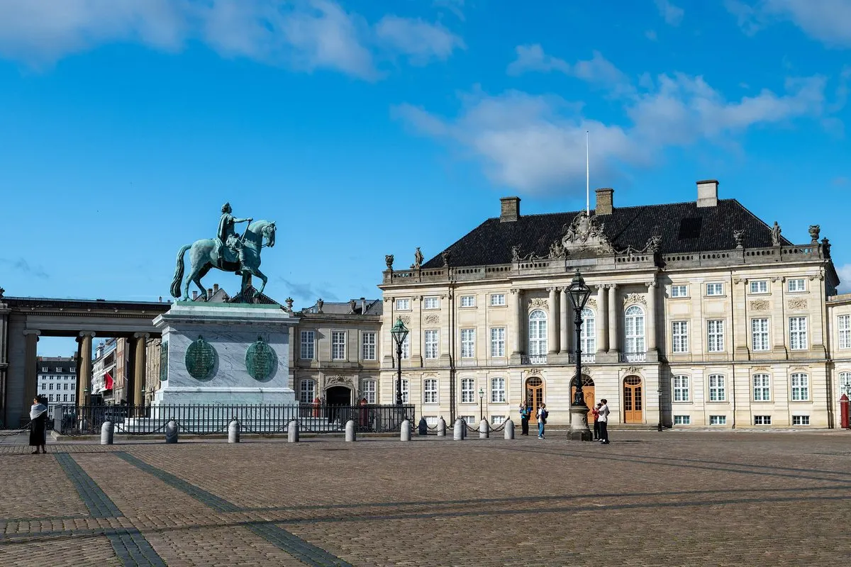 Amalienborg Palace square in Copenhagen with the equestrian statue of Frederick V under a blue sky
