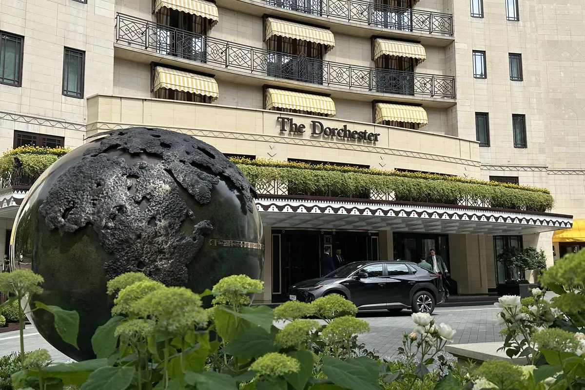 The entrance of The Dorchester on Park Lane, Mayfair, with a bronze globe sculpture in front