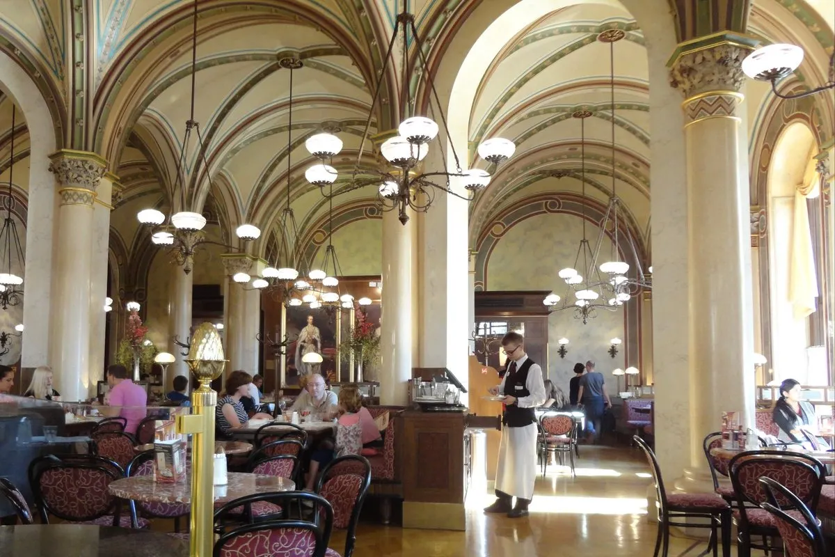 Vaulted interior of Café Central in the Palais Ferstel, Vienna, with marble tables and chandeliers