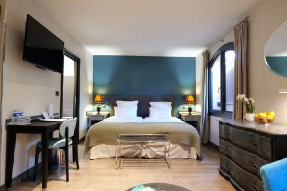 Modern hotel guest room with double bed and teal accent wall