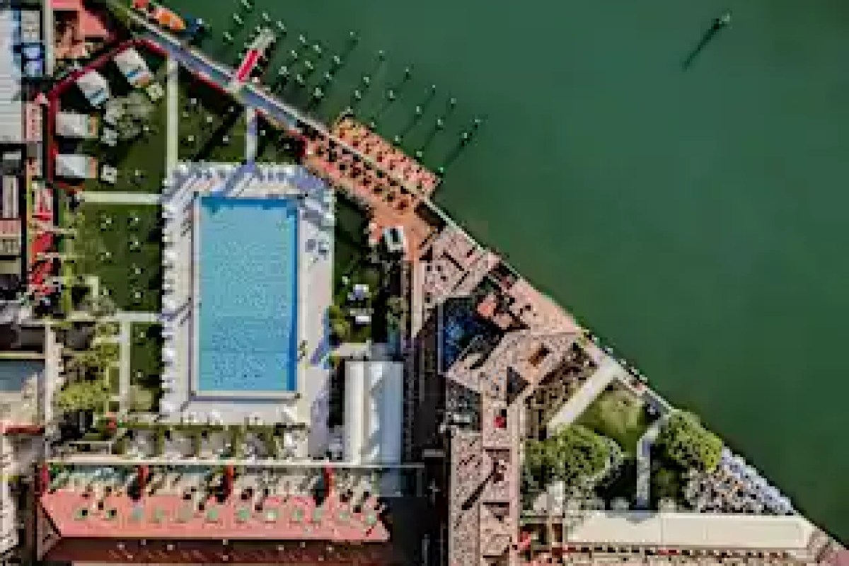 Aerial view of the hotel's rectangular pool and garden grounds beside the Venice lagoon