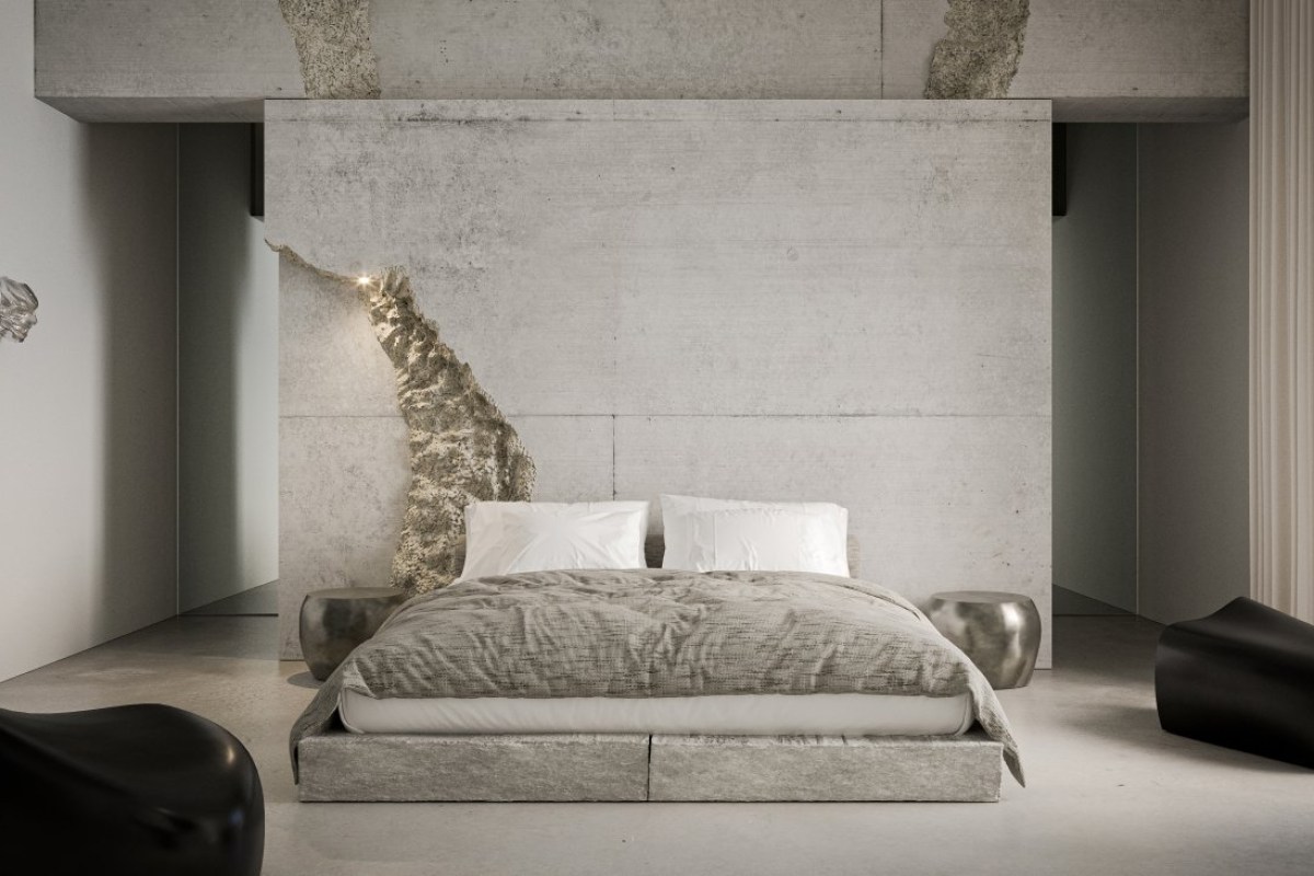 Minimalist bedroom with concrete wall, upholstered platform bed, and dark sculptural armchairs
