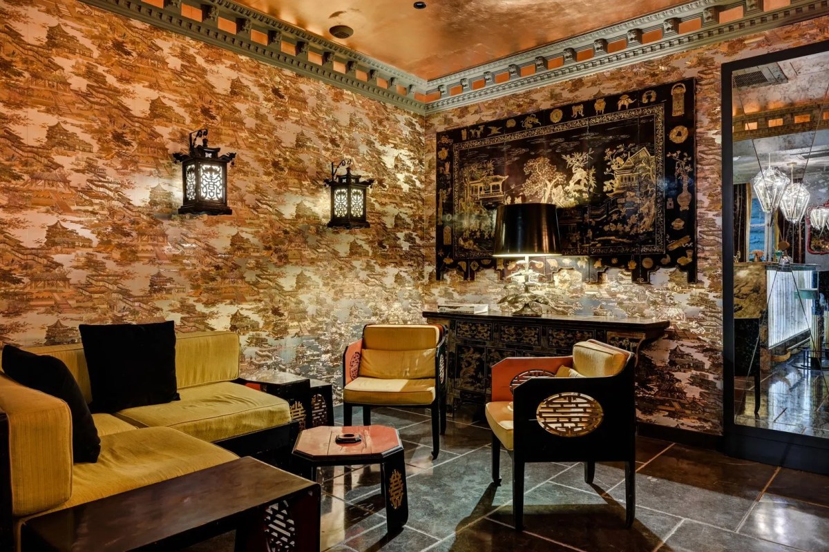 Ornate lounge area with Chinoiserie wallpaper, gold lanterns, and velvet seating