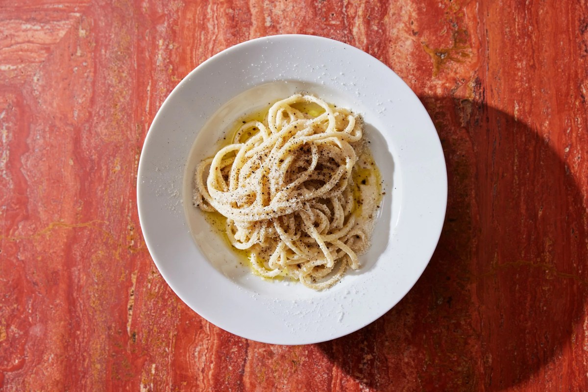 Plate of cacio e pepe pasta on a terrazzo-topped table