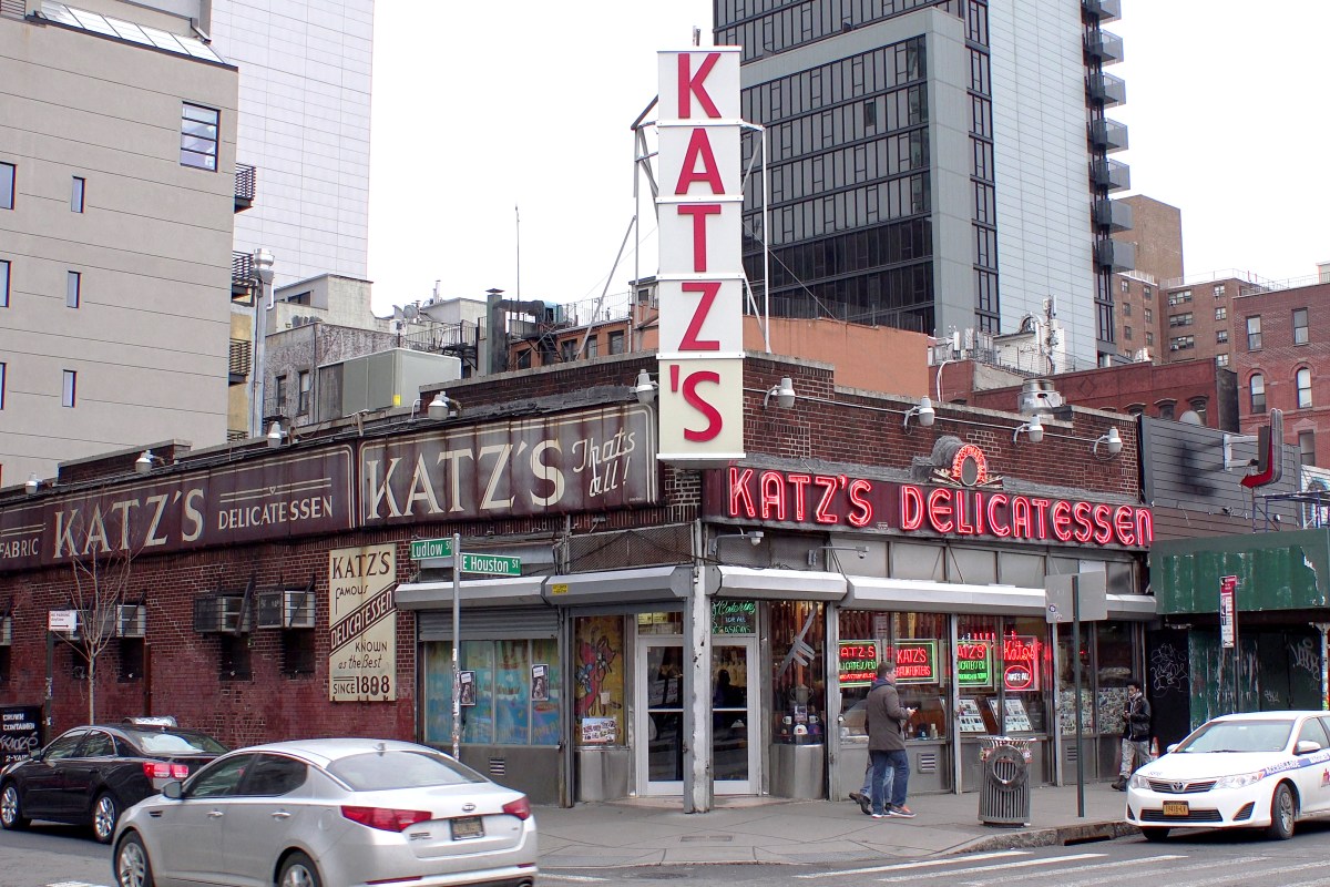 Katz's Delicatessen exterior corner view with neon sign and painted brick facade