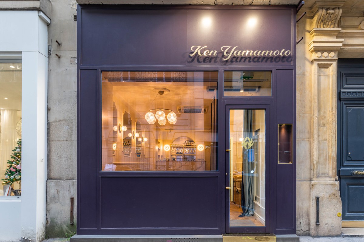 Ken Yamamoto restaurant exterior at dusk, purple facade with illuminated sign and glowing interior visible through window
