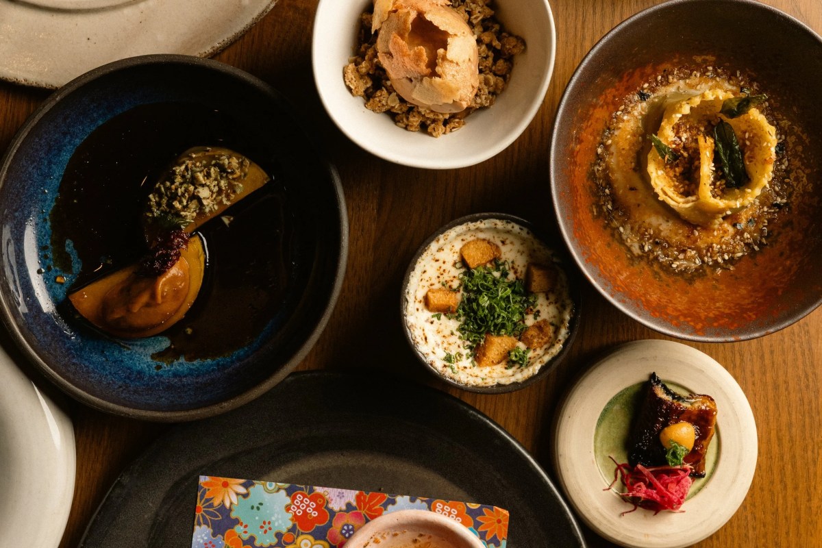 Overhead view of an assorted Japanese-inspired tasting spread with multiple small dishes