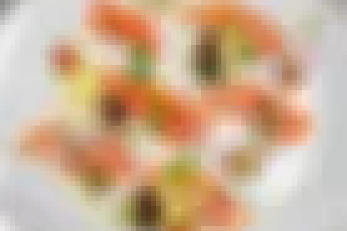 Close-up of a colorful plated dish with shrimp and garnishes