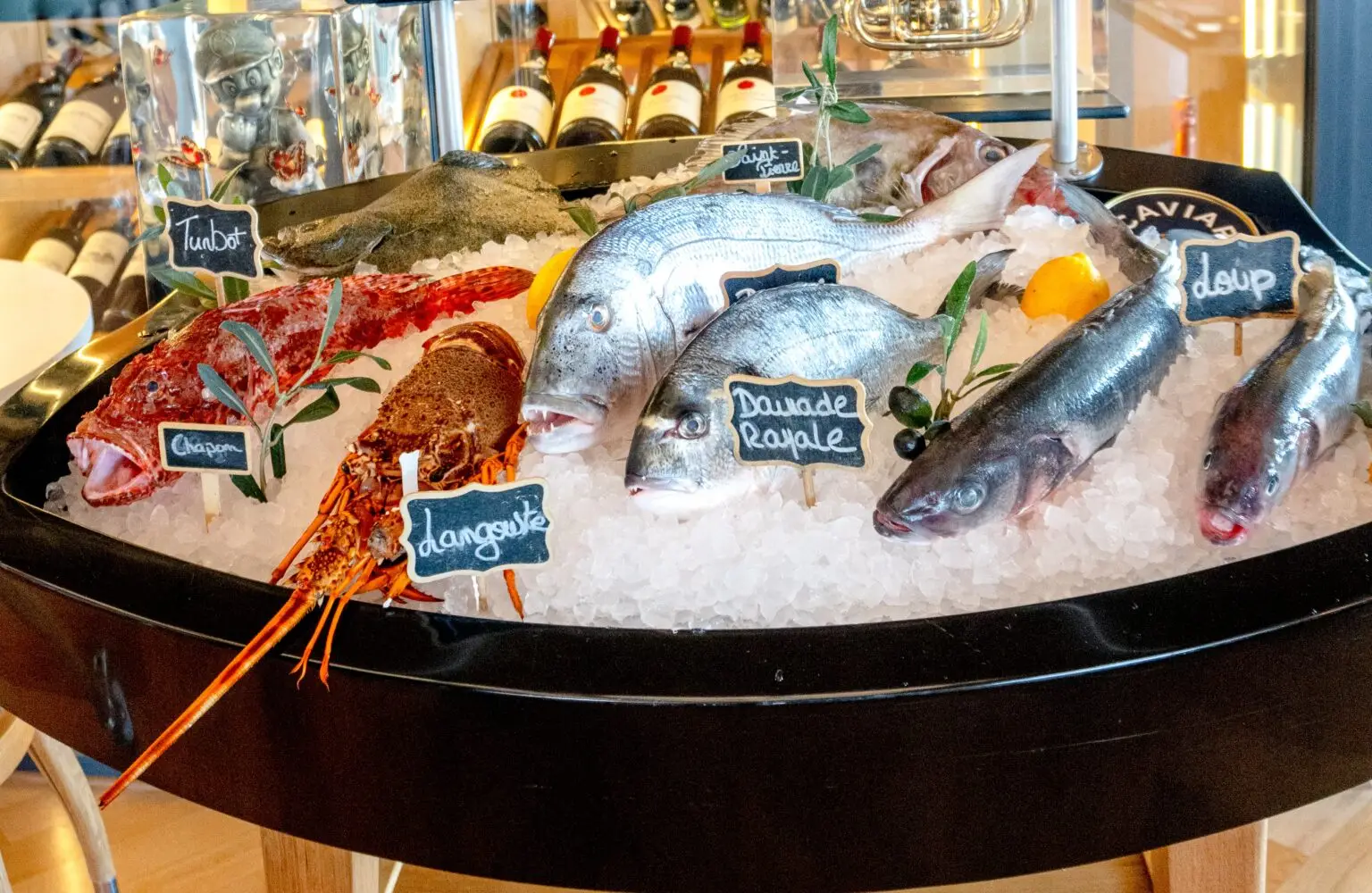 The day's catch on ice at La Maison de Bacon – sea bream, sea bass and a spiny lobster with handwritten labels