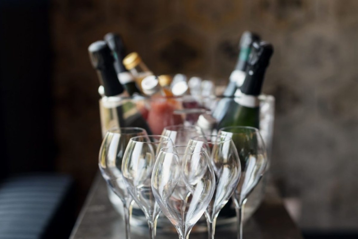 Champagne glasses and bottles arranged on a table, likely at the restaurant bar