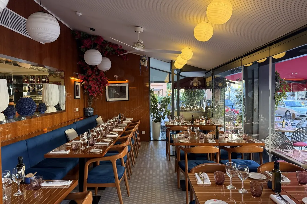 The dining room at La Salière with laid tables and large windows onto the harbour