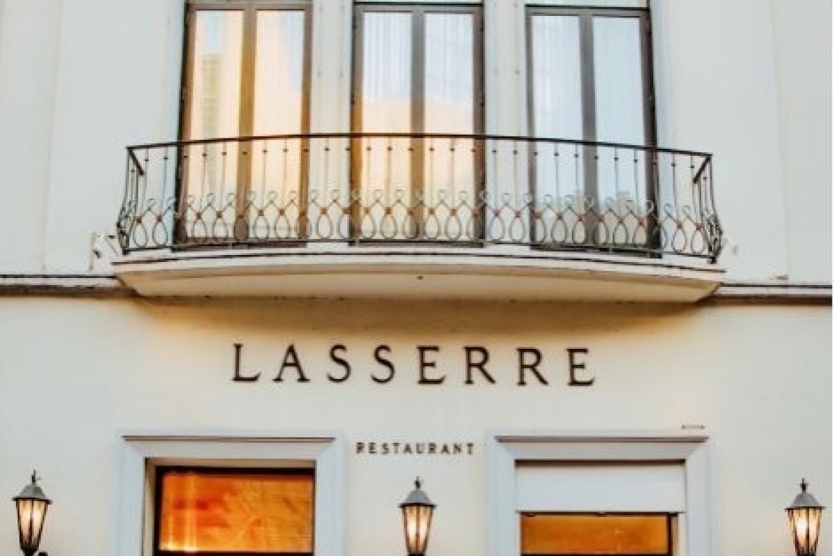 Exterior facade of Lasserre restaurant showing sign, balcony and windows
