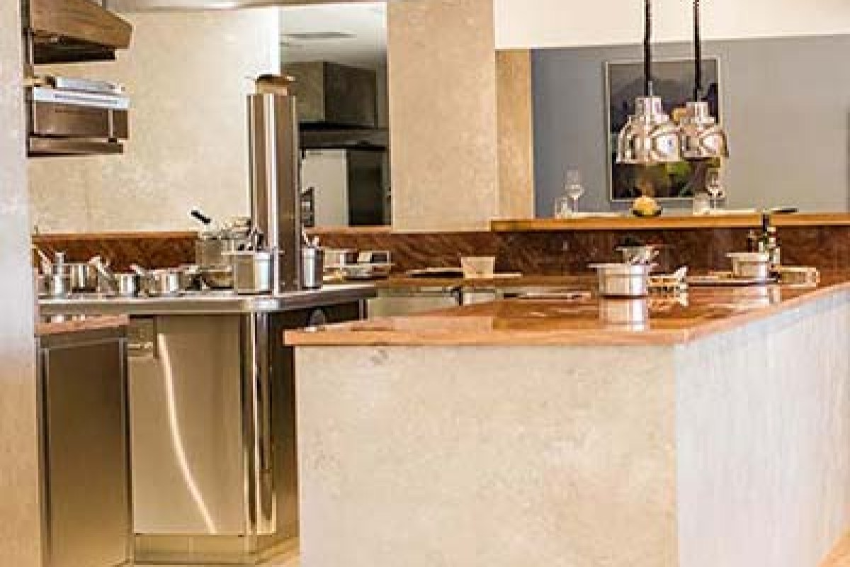 Restaurant bar/kitchen counter area with stone and wood finishes