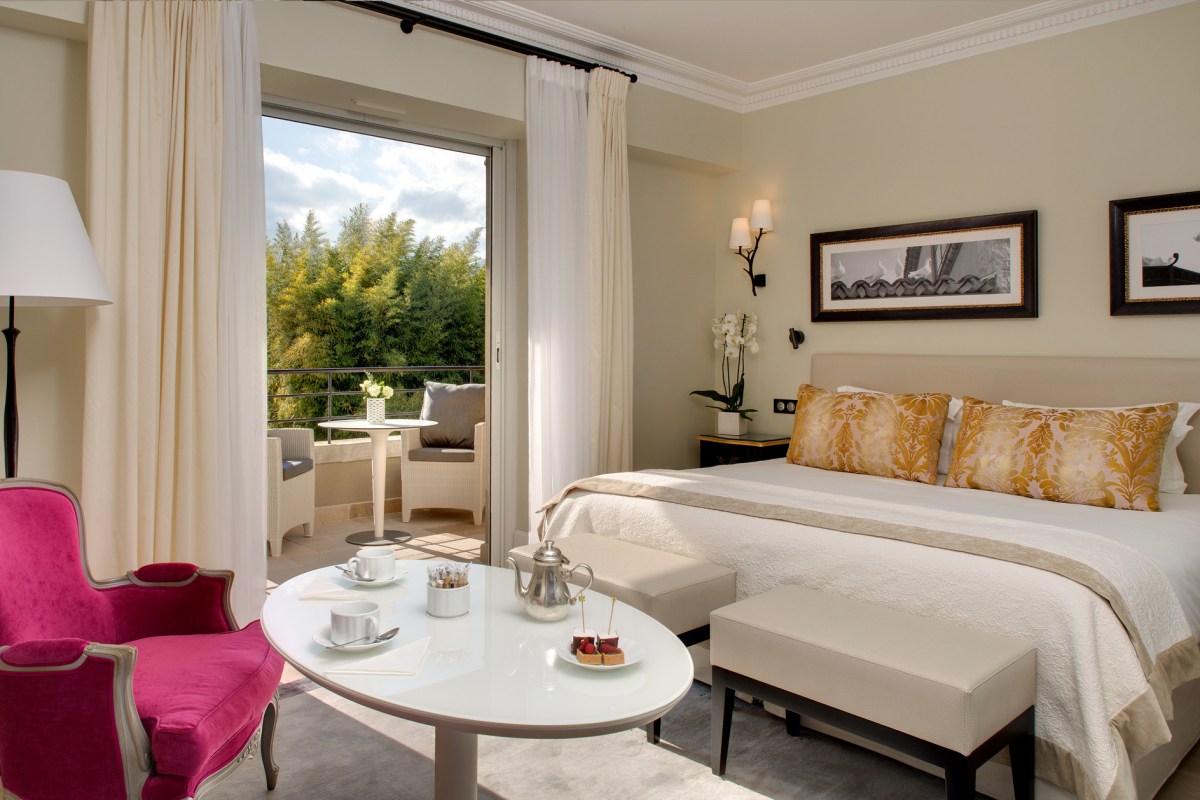 Spacious guest room with king bed, balcony access and city view